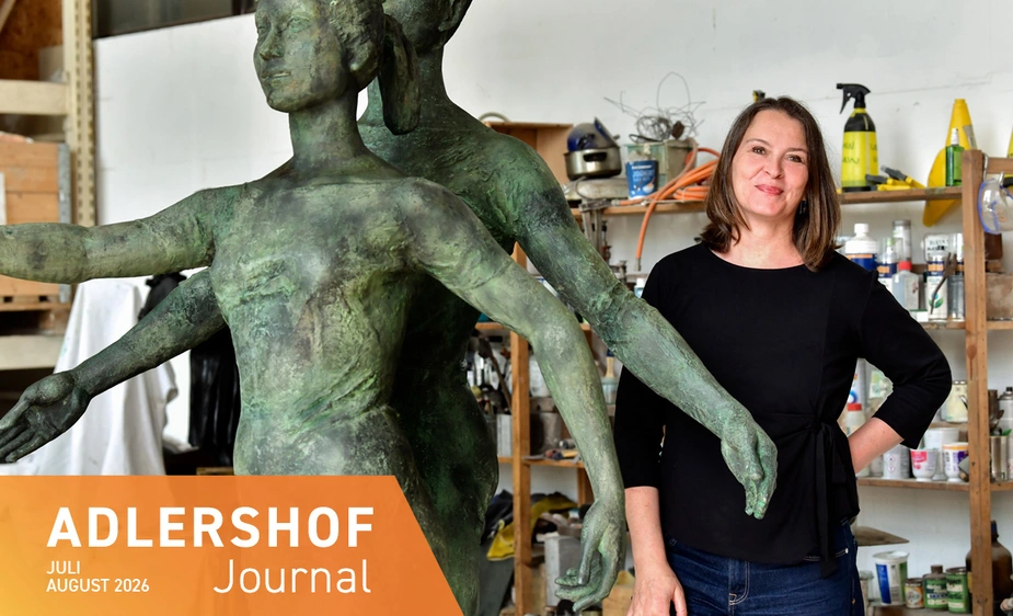 Anke Schirlitz standing next to a bronze sculpture