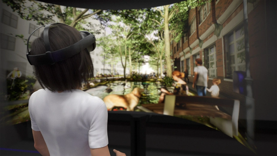A person with VR glasses observes a street scene.