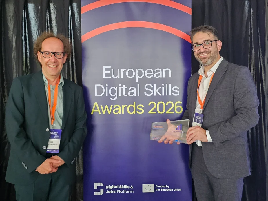 Two people with the award