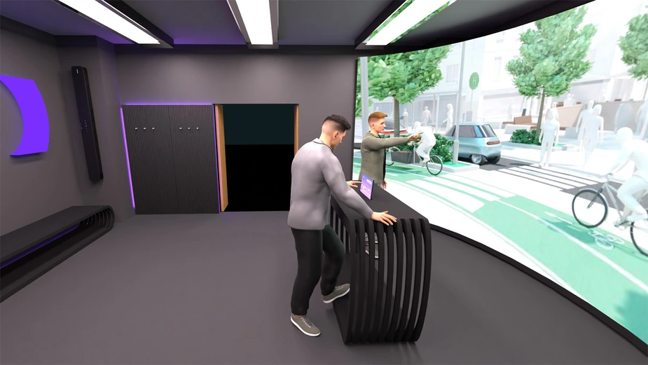 Two people are standing in front of a large screen and discussing the traffic situation shown.